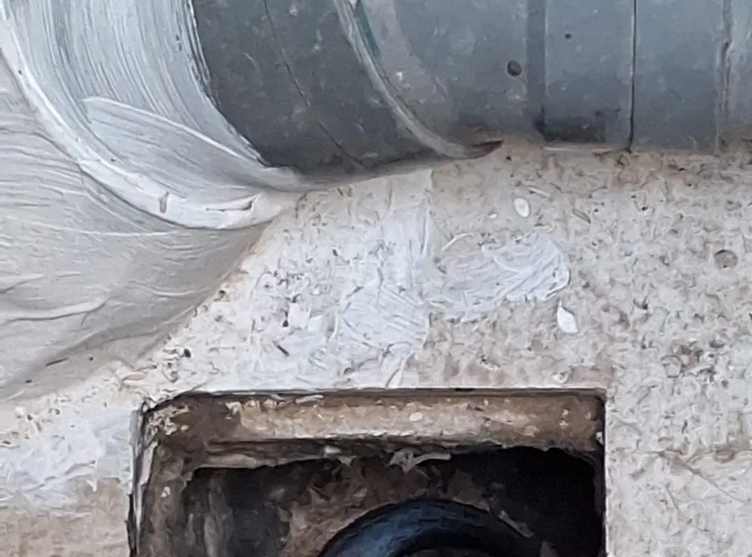 Drain access point opened for a leak inspection and water ingress check
