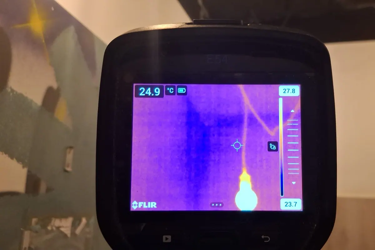 Thermal camera screen used to trace moisture near a ceiling leak concern